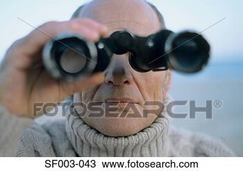 Stock Photo - senior man using 
binoculars. fotosearch 
- search stock 
photos, pictures, 
images, and photo 
clipart