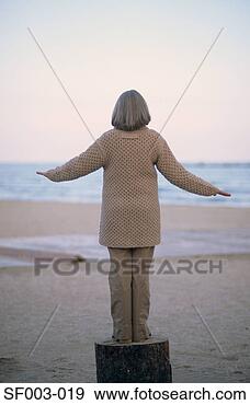 Stock Photograph - senior woman balancing 
on a log. fotosearch 
- search stock 
photos, pictures, 
images, and photo 
clipart