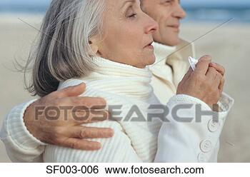 Stock Photo - senior woman sneezing 
and walking with 
senior man. fotosearch 
- search stock 
photos, pictures, 
images, and photo 
clipart