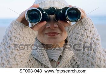 Stock Photo - senior woman using 
binoculars. fotosearch 
- search stock 
photos, pictures, 
images, and photo 
clipart