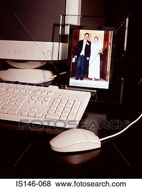 Stock Photo - wedding photograph 
near computer. 
fotosearch - search 
stock photos, 
pictures, images, 
and photo clipart