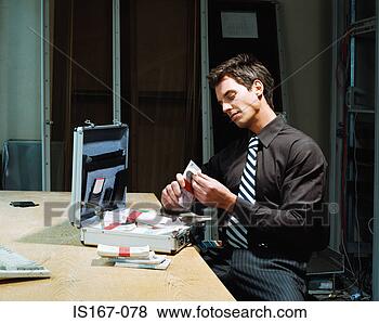 Stock Photo - man counting bundles 
of money. fotosearch 
- search stock 
photos, pictures, 
images, and photo 
clipart