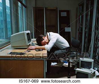 Stock Photograph - office worker 
slumped on his 
desk. fotosearch 
- search stock 
photos, pictures, 
images, and photo 
clipart