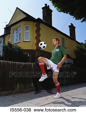 Stock Photo - footballer playing 
on pavement. fotosearch 
- search stock 
photos, pictures, 
images, and photo 
clipart