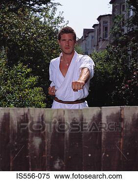 Stock Image - man doing karate 
in garden. fotosearch 
- search stock 
photos, pictures, 
images, and photo 
clipart
