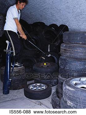 Stock Photo - man playing golf 
on tyres. fotosearch 
- search stock 
photos, pictures, 
images, and photo 
clipart