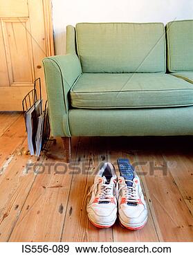 Stock Photograph - trainers and remote 
control in apartment. 
fotosearch - search 
stock photos, 
pictures, images, 
and photo clipart