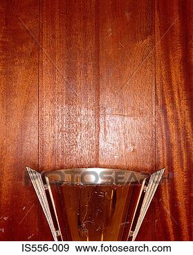 Stock Photograph - trophy against 
wooden wall. fotosearch 
- search stock 
photos, pictures, 
images, and photo 
clipart