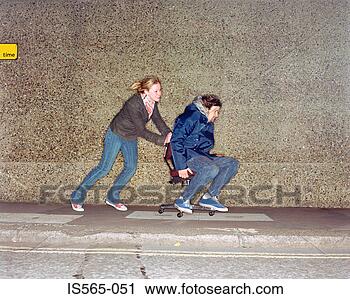 Stock Photography - couple playing 
on office chair. 
fotosearch - search 
stock photos, 
pictures, images, 
and photo clipart