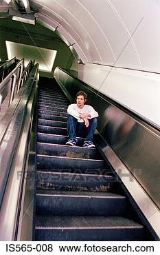 Stock Photo - man sitting on 
escalator. fotosearch 
- search stock 
photos, pictures, 
images, and photo 
clipart