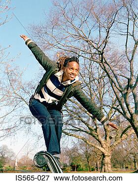 Picture - woman balancing 
on park bench. 
fotosearch - search 
stock photos, 
pictures, images, 
and photo clipart