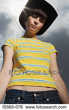 Stock Photo - young woman wearing 
a cowboy hat. 
fotosearch - search 
stock photos, 
pictures, images, 
and photo clipart