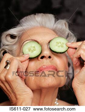 Picture - close-up of woman 
holding cucumbers 
over eyes. fotosearch 
- search stock 
photos, pictures, 
images, and photo 
clipart