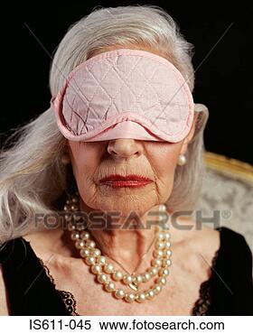 Stock Image - senior adult woman 
wearing pink eye 
mask. fotosearch 
- search stock 
photos, pictures, 
images, and photo 
clipart