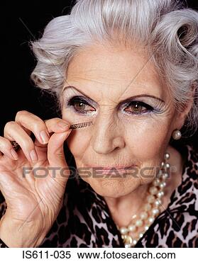 Stock Image - senior woman applying 
fake eyelashes. 
fotosearch - search 
stock photos, 
pictures, images, 
and photo clipart