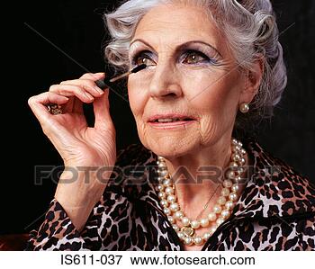 Picture - senior woman applying 
mascara. fotosearch 
- search stock 
photos, pictures, 
images, and photo 
clipart