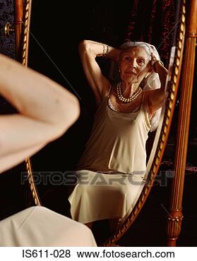 Stock Photo - senior woman looking 
in the mirror. 
fotosearch - search 
stock photos, 
pictures, images, 
and photo clipart