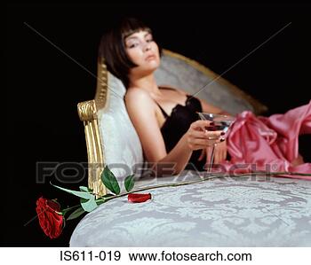 Stock Photograph - woman with cocktail 
glass and rose. 
fotosearch - search 
stock photos, 
pictures, images, 
and photo clipart