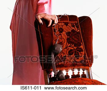 Stock Photography - woman dangling 
telephone handset 
over chair. fotosearch 
- search stock 
photos, pictures, 
images, and photo 
clipart