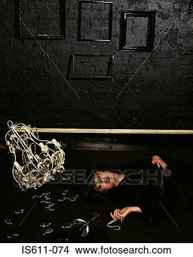 Stock Photo - woman lying on 
floor with broken 
chandelier. fotosearch 
- search stock 
photos, pictures, 
images, and photo 
clipart