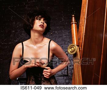 Stock Photograph - young woman adjusting 
fake breast. fotosearch 
- search stock 
photos, pictures, 
images, and photo 
clipart