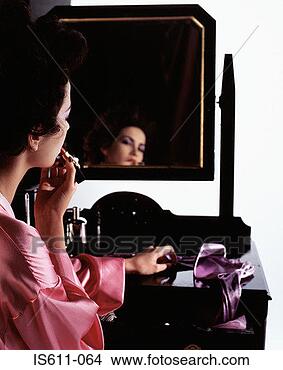 Stock Photo - young woman applying 
makeup. fotosearch 
- search stock 
photos, pictures, 
images, and photo 
clipart