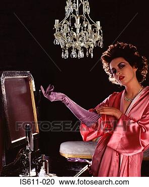 Stock Photography - young woman putting 
on satin glove. 
fotosearch - search 
stock photos, 
pictures, images, 
and photo clipart