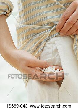 Stock Photo - woman taking handful 
of drugs from 
her pocket. fotosearch 
- search stock 
photos, pictures, 
images, and photo 
clipart