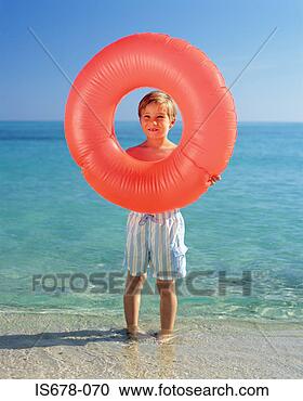 Stock Photography - boy holding inflatable 
ring. fotosearch 
- search stock 
photos, pictures, 
images, and photo 
clipart