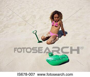 Picture - girl playing in 
the sand. fotosearch 
- search stock 
photos, pictures, 
images, and photo 
clipart