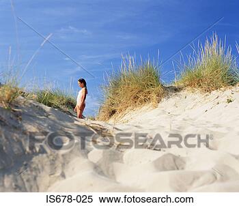 Stock Image - girl standing 
in a sand dune. 
fotosearch - search 
stock photos, 
pictures, images, 
and photo clipart
