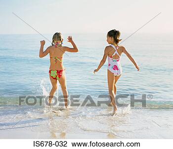 Stock Photo - girls splashing 
in the sea. fotosearch 
- search stock 
photos, pictures, 
images, and photo 
clipart