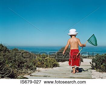 Picture - boy walking to 
beach with a fishing 
net. fotosearch 
- search stock 
photos, pictures, 
images, and photo 
clipart