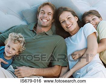 Stock Photo - family lying on 
cushions. fotosearch 
- search stock 
photos, pictures, 
images, and photo 
clipart