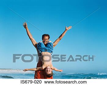 Stock Photography - father holding 
son upside down. 
fotosearch - search 
stock photos, 
pictures, images, 
and photo clipart