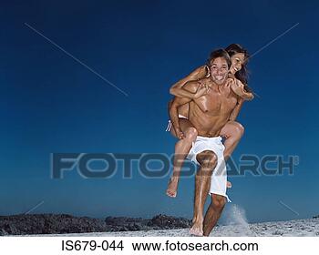 Stock Photo - man giving wife 
a piggyback. fotosearch 
- search stock 
photos, pictures, 
images, and photo 
clipart