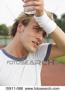 Stock Photo - tennis player 
wiping his forehead. 
fotosearch - search 
stock photos, 
pictures, images, 
and photo clipart