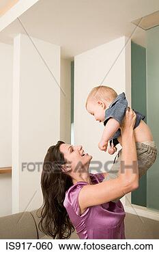 Stock Photography - woman lifting 
her baby up. fotosearch 
- search stock 
photos, pictures, 
images, and photo 
clipart