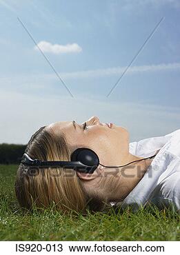 Stock Photo - woman listening 
to music in a 
park. fotosearch 
- search stock 
photos, pictures, 
images, and photo 
clipart