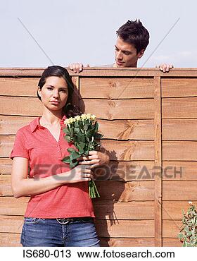 Stock Photo - man looking at 
woman over garden 
fence. fotosearch 
- search stock 
photos, pictures, 
images, and photo 
clipart
