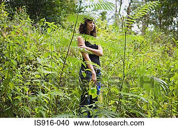 Stock Photography - young woman standing 
amongst fern. 
fotosearch - search 
stock photos, 
pictures, images, 
and photo clipart