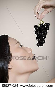 Stock Photo - woman holding 
bunch of grapes. 
fotosearch - search 
stock photos, 
pictures, images, 
and photo clipart
