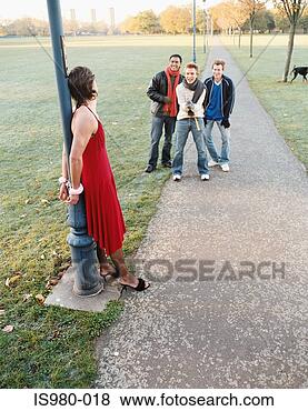 Stock Photo - man handcuffed 
to lamp post being 
laughed at. fotosearch 
- search stock 
photos, pictures, 
images, and photo 
clipart
