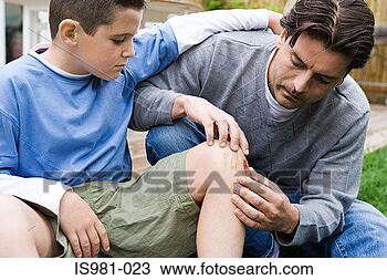 Stock Photo - father looking 
at son's grazed 
knee. fotosearch 
- search stock 
photos, pictures, 
images, and photo 
clipart