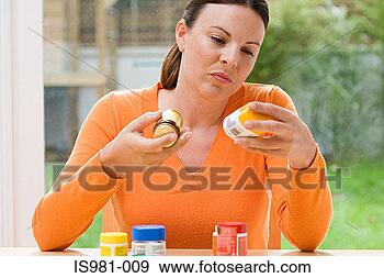 Stock Photograph - woman choosing 
between supplements. 
fotosearch - search 
stock photos, 
pictures, images, 
and photo clipart