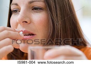 Stock Photo - woman taking a 
tablet. fotosearch 
- search stock 
photos, pictures, 
images, and photo 
clipart
