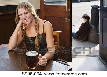 Stock Photo - young woman drinking 
in pub. fotosearch 
- search stock 
photos, pictures, 
images, and photo 
clipart