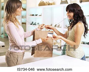 Stock Photo - woman and sales 
assistant. fotosearch 
- search stock 
photos, pictures, 
images, and photo 
clipart