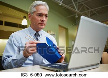 Stock Photography - man eating chinese 
food at desk. 
fotosearch - search 
stock photos, 
pictures, images, 
and photo clipart