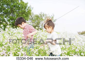 Stock Photo - children exploring 
in a field. fotosearch 
- search stock 
photos, pictures, 
images, and photo 
clipart
